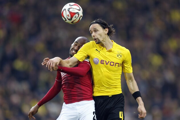Hannover’s Jimmy Briand from France, left and Dortmund's Neven Subotic from Serbia challenge for the ball during the German first division Bundesliga soccer match between BvB Borussia Dortmund  and Hannover 96 in Dortmund, Germany, Saturday, Oct. 25, 2014. (AP Photo/Frank Augstein)