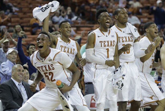 Texas player Myles Turner (52), Demarcus Holland, second from left, Isaiah Taylor (1), Jonathan Holmes (10) and Jordan Barnett (33) cheer for walk-on teammate Ryan McClurg's score during the final seconds of the second half of an NCAA college basketball game against Alcorn State, Sunday, Nov. 16, 2014, in Austin, Texas. Texas won 85-53. (AP Photo/Eric Gay)