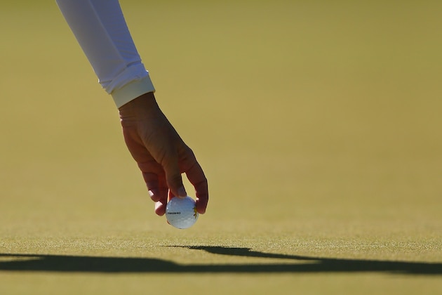 MELBOURNE, AUSTRALIA - FEBRUARY 21:  Karrie Webb of Australia takes out her ball from the cup  on the 11th hole during day three of the LPGA Australian Open at Royal Melbourne Golf Course on February 21, 2015 in Melbourne, Australia.  (Photo by Michael Dodge/Getty Images)