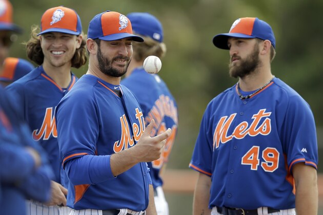 New York Mets pitcher Matt Harvey, center, flips a ball alongside teammates Jacob deGrom, left, and Jonathon Niese during spring training baseball practice Thursday, Feb. 26, 2015, in Port St. Lucie, Fla. (AP Photo/Jeff Roberson)