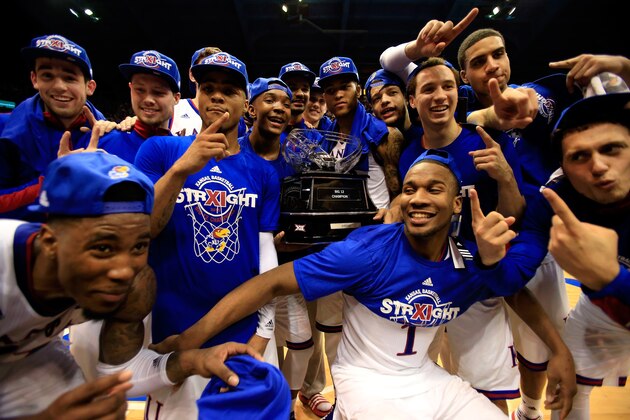 LAWRENCE, KS - MARCH 03:  The Kansas Jayhawks pose with the trophy after defeating the West Virginia Mountaineers to win the game and clinch an eleventh-straight Big IX Championship title at Allen Fieldhouse on March 3, 2015 in Lawrence, Kansas.  (Photo by Jamie Squire/Getty Images)