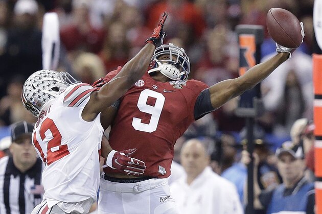 Alabama wide receiver Amari Cooper (9) tries to catch the ball as Ohio State cornerback Doran Grant (12) defends during the Sugar Bowl NCAA college football playoff semifinal game, Thursday, Jan. 1, 2015, in New Orleans. (AP Photo/Brynn Anderson)