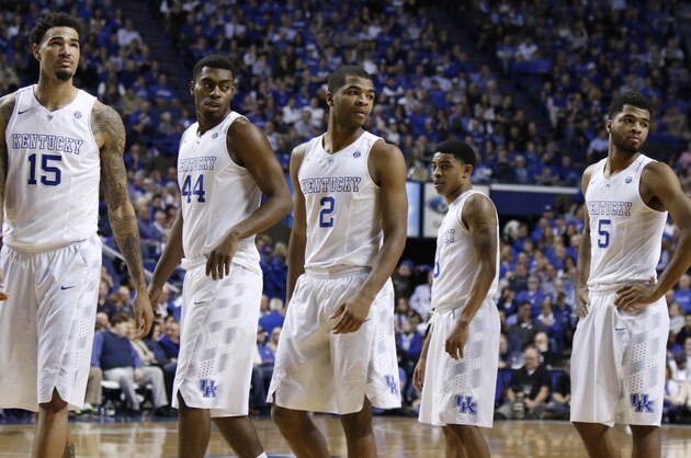 Kentucky players, from left, Willie Cauley-Stein, Dakari Johnson, Aaron Harrison, Tyler Ulis and Andrew Harrison re-enter the game during the second half of an NCAA college basketball game against Florida, Saturday, March 7, 2015, in Lexington, Ky. Kentucky won 67-50. (AP Photo/James Crisp)