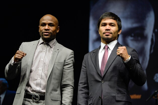 Mar 11, 2015; Los Angeles, CA, USA; Floyd Mayweather (left) and Manny Pacquiao pose for photographers during a press conference to announce their fight on May 2, 2015 at Los Angeles. Mandatory Credit: Robert Hanashiro-USA TODAY Sports