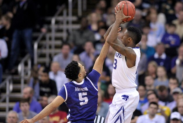 Mar 11, 2015; Kansas City, MO, USA; Kansas State Wildcats guard Nigel Johnson (23) shoots the ball as TCU Horned Frogs guard Kyan Anderson (5) defends during the first round of the Big 12 Championship at the Sprint Center. Mandatory Credit: Denny Medley-USA TODAY Sports