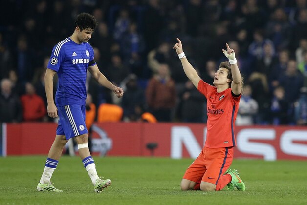 PSG's David Luiz, right, celebrates at the final whistle as Chelsea's Diego Costa, right, leaves the field after the Champions League round of 16 second leg soccer match between Chelsea and Paris Saint Germain at Stamford Bridge stadium in London, Wednesday, March 11, 2015. The ended in a 2-2 draw with PSG going through on away goals.  (AP Photo/Matt Dunham)