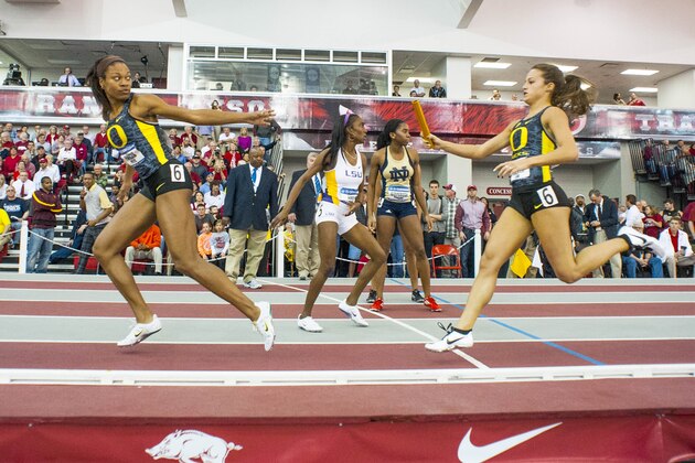 Oregon's Laura Roesler, front right, prepares to hand off the baton to teammate Phyllis Francis, left, during the 4x400-meter relay at the NCAA Division I Indoor Track and Field Championship in Fayetteville, Ark., Saturday, March 9, 2013. (AP Photo/April L. Brown)