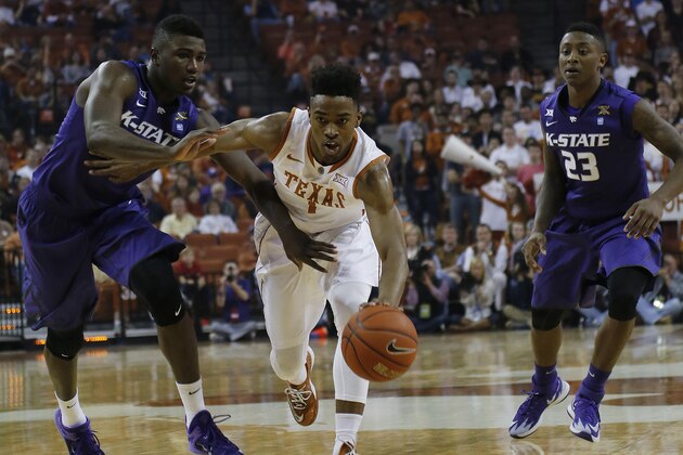 AUSTIN, TX - MARCH 7: Isaiah Taylor #1 of the Texas Longhorns drives around Malek Harris #10 of the Kansas State Wildcats at the Frank Erwin Center on March 2, 2015 in Austin, Texas. (Photo by Chris Covatta/Getty Images)