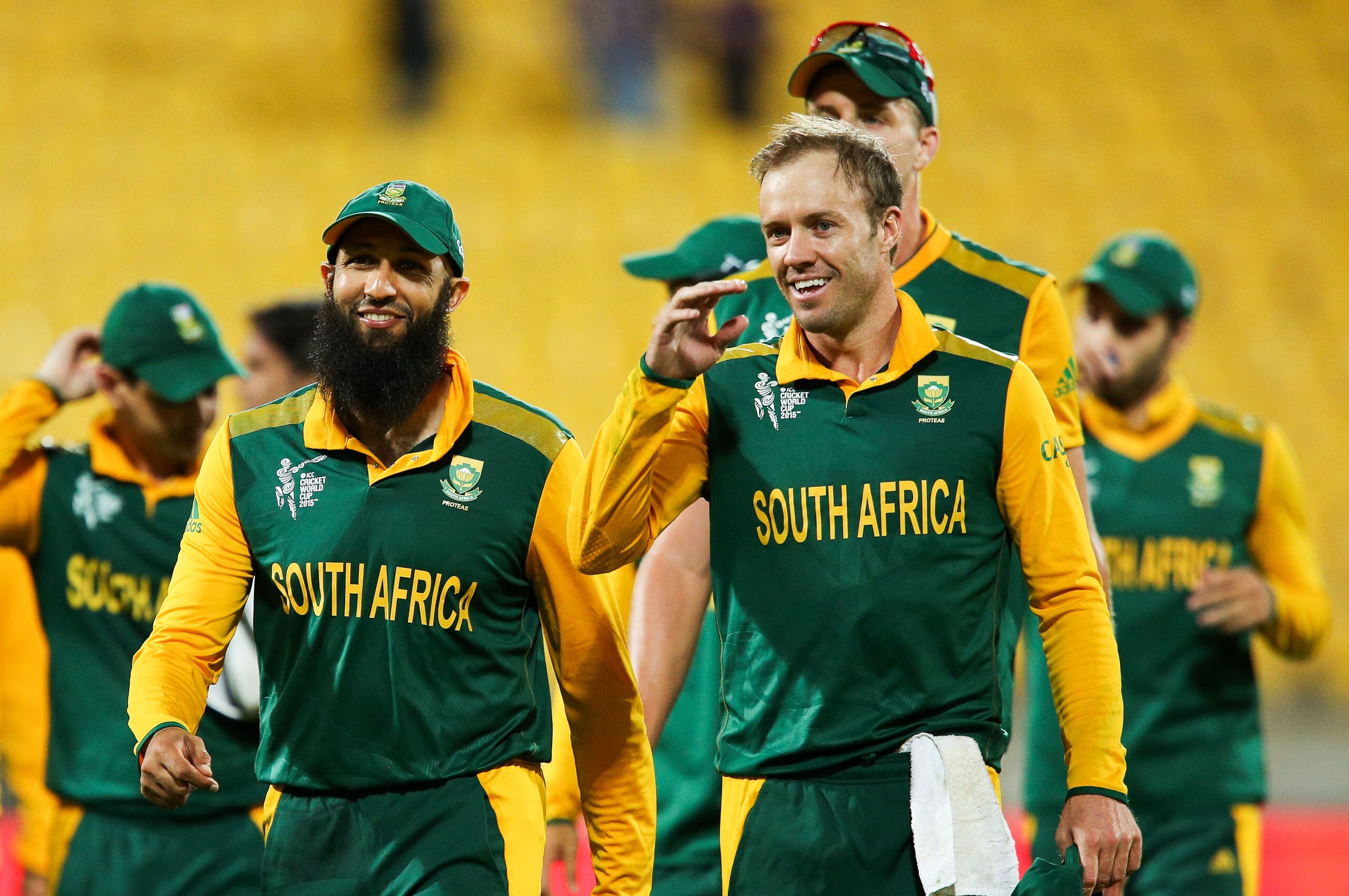 WELLINGTON, NEW ZEALAND - MARCH 12:  Hashim Amla (L) and AB de Villiers of South Africa are all smiles after winning the 2015 ICC Cricket World Cup match between South Africa and the United Arab Emirates at Wellington Regional Stadium on March 12, 2015 in Wellington, New Zealand.  (Photo by Hagen Hopkins/Getty Images)