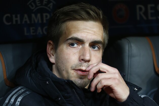 Bayern's Philipp Lahm sits in the dugout during the Champions League round of 16 second leg soccer match between Bayern Munich and Shakhtar Donetsk Wednesday, March 11, 2015 in Munich, southern Germany. (AP Photo/Matthias Schrader)