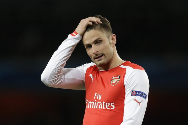 Arsenal's Olivier Giroud touches his head during the Champions League round of 16 soccer match between Arsenal and AS Monaco at the Emirates Stadium in London, Wednesday, Feb. 25, 2015.  (AP Photo/Matt Dunham)