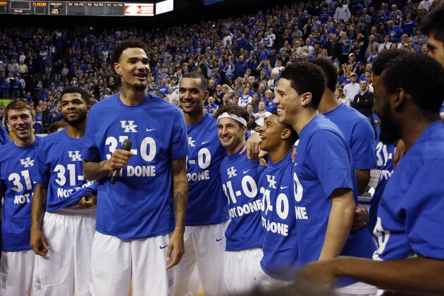 Kentuck's Willie Cauley-Stein, fourth from left, celebrates with teammates during a ceremony marking the teams undefeated regular season after an NCAA college basketball game, Saturday, March 7, 2015, in Lexington, Ky. Kentucky won 67-50. (AP Photo/James Crisp)