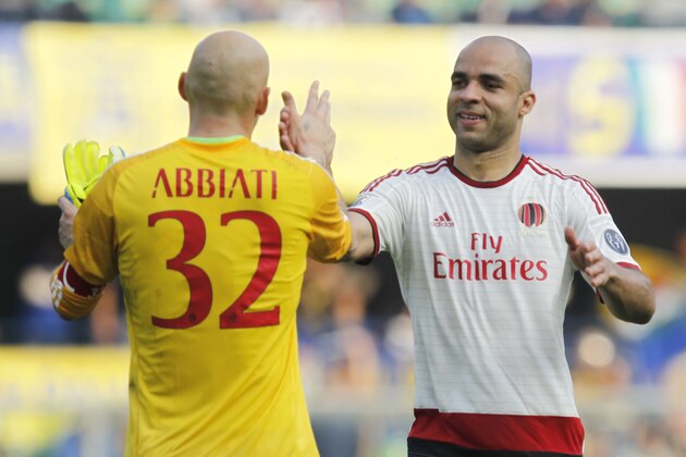 AC Milan's Christian Abbiati, left, congratulates teammate Alex at the end of a Serie A soccer match against Hellas Verona at the Bentegodi stadium in Verona, Italy, Sunday, Oct. 19, 2014. AC Milan won 3-1. (AP Photo/Felice Calabro')