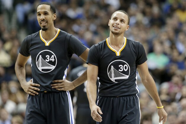 Golden State Warriors guard Stephen Curry (30) smiles as he and Shaun Livingston (34) walk up court after Curry sunk a shot and a foul was called against the Dallas Mavericks in the second half of an NBA basketball game, Saturday, Dec. 13, 2014, in Dallas. The Warriors won 105-98. (AP Photo/Tony Gutierrez)
