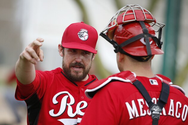 Cincinnati Reds' Sam LeCure, left, speaks with Devin Mesoraco during a spring training baseball workout Monday, Feb. 23, 2015, in Goodyear, Ariz. (AP Photo/John Locher)