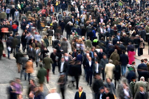 CHELTENHAM, ENGLAND - MARCH 12: Racegoers make their way around the enclosures at Cheltenham racecourse on March 12, 2015 in Cheltenham, England. (Photo by Alan Crowhurst/Getty Images)
