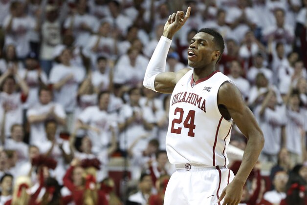 Oklahoma guard Buddy Hield (24) gestures to the crowd following a basket in the second half of an NCAA college basketball game against Kansas in Norman, Okla., Saturday, March 7, 2015. Oklahoma won 75-73. (AP Photo/Sue Ogrocki)