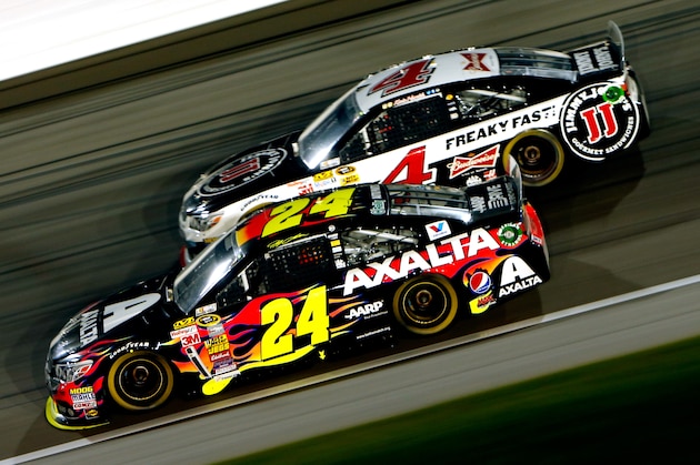 KANSAS CITY, KS - MAY 10:  Jeff Gordon, driver of the #24 Axalta Coatings Chevrolet, races Kevin Harvick, driver of the #4 Jimmy John's Chevrolet, during the NASCAR Sprint Cup Series 5-Hour Energy 400 at Kansas Speedway on May 10, 2014 in Kansas City, Kansas.  (Photo by Kyle Rivas/Getty Images)