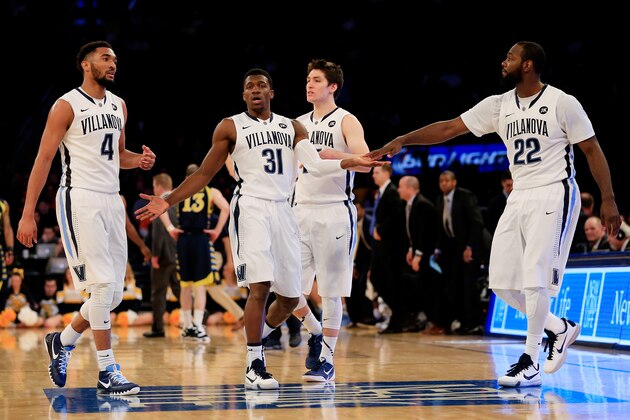 NEW YORK, NY - MARCH 12: Dylan Ennis #31 celebrates with JayVaughn Pinkston #22 of the Villanova Wildcats against the Marquette Golden Eagles during a quarterfinal game of the Big East basketball tournament at Madison Square Garden on March 12, 2015 in New York City.  (Photo by Alex Trautwig/Getty Images)