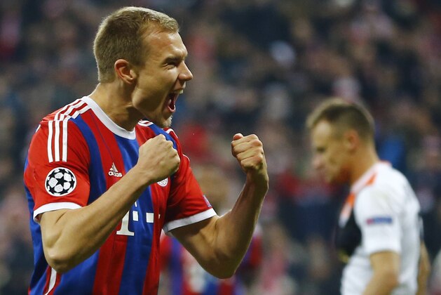 Bayern's Holger Badstuber celebrates scoring 5-0 during the Champions League round of 16 second leg soccer match between Bayern Munich and Shakhtar Donetsk Wednesday, March 11, 2015 in Munich, southern Germany. Right is Shakhtar's Vyacheslav Shevchuk. (AP Photo/Matthias Schrader)