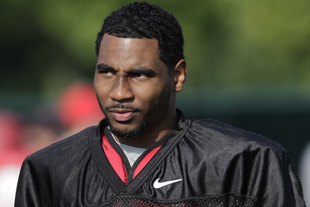 FILE - In this Aug. 9, 2014, file photo, Ohio State quarterback Braxton Miller watches teammates warm up during an NCAA college football practice in Columbus, Ohio. Miller, among the top contenders for the Heisman Trophy, reportedly reinjured his throwing shoulder during practice. The report about the two-time Big Ten offensive player of the year comes with just more than two weeks before the No. 5 Buckeyes open the season. (AP Photo/Jay LaPrete, File)