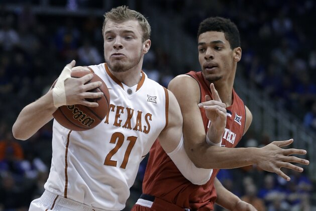 Texas forward Connor Lammert (21) rebounds against Texas Tech forward Zach Smith during the first half of an NCAA college basketball game in the first round of the Big 12 Conference tournament in Kansas City, Mo., Wednesday, March 11, 2015. (AP Photo/Orlin Wagner)