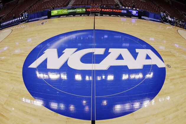 FILE - In this March 21, 2013, file photo, in this image taken with a fisheye lens, the NCAA logo is displayed at mid-court before Albany's practice for a second-round game of the NCAA college basketball tournament in Philadelphia. Barely a month ago, the NCAA was shamed into apologizing for trying to rig its own investigation into funny business at the University of Miami. According to a new report, that apology didn't go nearly far enough. (AP Photo/Matt Slocum, File)