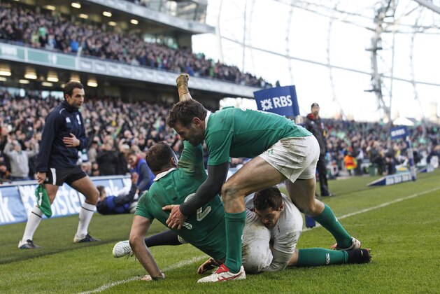 Ireland's Robbie Henshaw, left, celebrates after scoring a try despite the challenge of England's Alex Goode during their rugby union 6 nations match at the Aviva stadium, Dublin, Ireland, Sunday, March, 1, 2015. (AP Photo/Peter Morrison) Ireland's Robbie Henshaw, left, celebrates after scoring a try despite the challenge of England's Alex Goode during their rugby union 6 nations match at the Aviva stadium, Dublin, Ireland, Sunday, March, 1, 2015. (AP Photo/Peter Morrison)