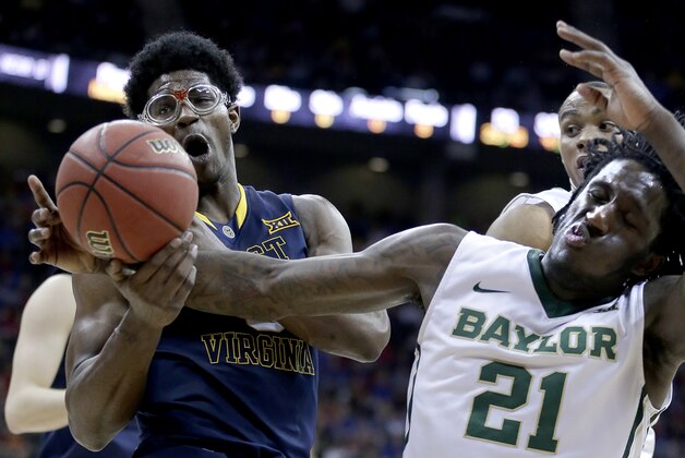 Baylor's Taurean Prince (21) attempts to steals the ball from West Virginia's Devin Williams, left, during the second half of an NCAA college basketball game in the quarterfinals of the Big 12 Conference tournament Thursday, March 12, 2015, in Kansas City, Mo. Baylor won 80-70. (AP Photo/Charlie Riedel)