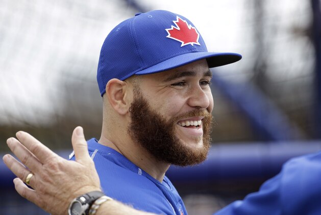 Toronto Blue Jays catcher Russell Martin is patted on the back during a spring training baseball workout, Monday, Feb. 23, 2015, in Dunedin, Fla. (AP Photo/Lynne Sladky)