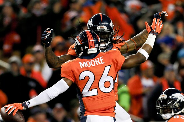 Denver Broncos free safety Rahim Moore (26) celebrates his interception with teammate T.J. Ward against the Indianapolis Colts during the second half of an NFL divisional playoff football game, Sunday, Jan. 11, 2015, in Denver. (AP Photo/Joe Mahoney)