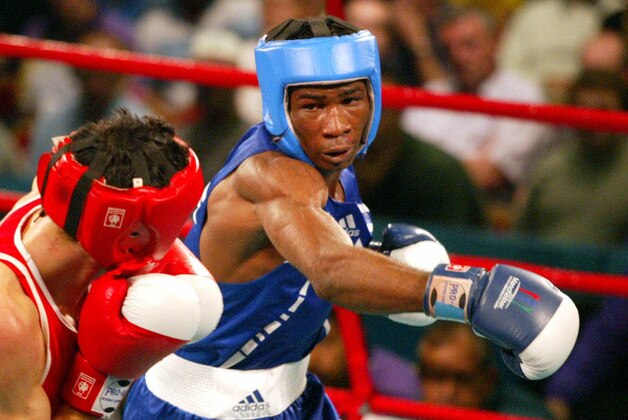UNITED KINGDOM - AUGUST 01:  New Zealand boxer Daniel Codling in red boxes with Olanrewaju Ekundayo from Nigeria, during their quater final fight in the welterweight division, during the XVII Commonwealth Games, Wednesday. Codling won on points 3724.  (Photo by Michael Bradley/Getty Images)