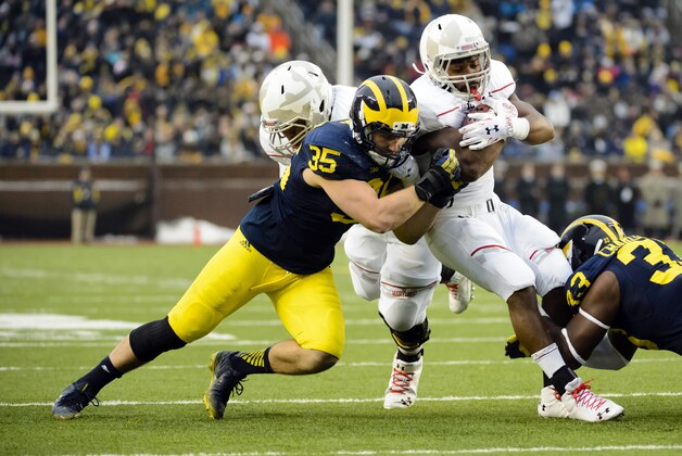 Nov 22, 2014; Ann Arbor, MI, USA; Michigan Wolverines linebacker Joe Bolden (35) tackles Maryland Terrapins running back Brandon Ross (45) at Michigan Stadium. Mandatory Credit: Rick Osentoski-USA TODAY Sports