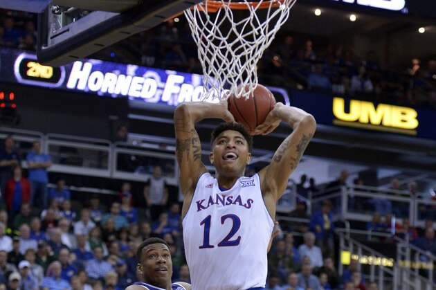 Mar 12, 2015; Kansas City, MO, USA; Kansas Jayhawks guard Kelly Oubre Jr. (12) dunks the ball as TCU Horned Frogs forward Brandon Parrish (11) tries to defend during the first round at Sprint Center. Kansas won 64-59. Mandatory Credit: Denny Medley-USA TODAY Sports