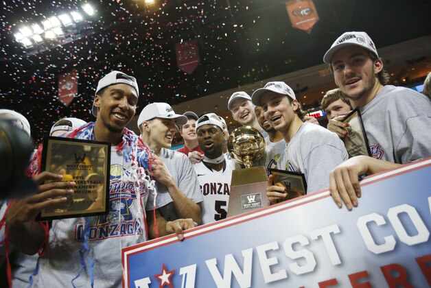 Gonzaga players pose for photos after they defeated BYU in the West Coast Conference tournament championship NCAA college basketball game Tuesday, March 10, 2015, in Las Vegas. Gonzaga won 91-75. (AP Photo/John Locher)