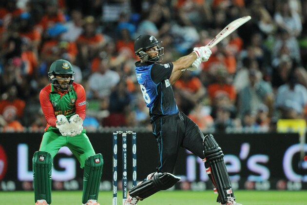 New Zealand’s Martin Guptill hits the ball as Bangladesh wicketkeeper Mushfiqur Rahim  watches during their Cricket World Cup Pool A match in Hamilton, New Zealand, Friday, March 13, 2015. (AP Photo/Ross Setford)