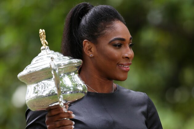 Serena Williams of the U.S. poses with her Australian Open trophy the day after defeating Russia's Maria Sharapova in the women's singles final at the Australian Open tennis championship in Melbourne, Australia, Sunday, Feb. 1, 2015. (AP Photo/Rob Griffith)