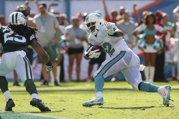 MIAMI GARDENS, FL - DECEMBER 28:  Tight end Charles Clay #42 of the Miami Dolphins runs enroute to his second quarter touchdown as free safety Calvin Pryor #25 of the New York Jets defends during a game at Sun Life Stadium on December 28, 2014 in Miami Gardens, Florida.  (Photo by Mike Ehrmann/Getty Images)