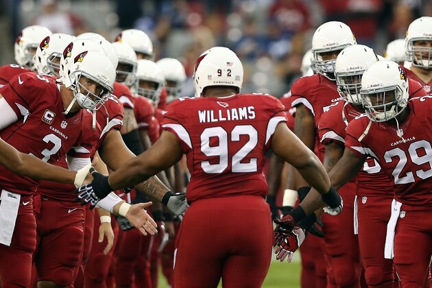 GLENDALE, AZ - NOVEMBER 24:  Quarterback Carson Palmer #3 and running back Alfonso Smith #29 of the Arizona Cardinals high five nose tackle Dan Williams #92 as he is introduced to the NFL game against the Indianapolis Colts at the University of Phoenix Stadium on November 24, 2013 in Glendale, Arizona.  The Cardinals defeated the Colts 40-11.  (Photo by Christian Petersen/Getty Images)