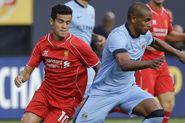 Manchester City midfielder Fernando, right, keeps the ball from Liverpool midfielder Philippe Coutinho (10) in the first half of a Guinness International Champions Cup soccer tournament match, Wednesday, July 30, 2014, at Yankee Stadium in New York. (AP Photo/Julie Jacobson)