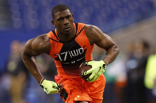 Michigan wide receiver Devin Funchess runs a drill at the NFL football scouting combine in Indianapolis, Saturday, Feb. 21, 2015. (AP Photo/Julio Cortez)