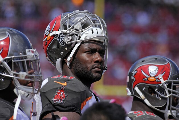 Oct 12, 2014; Tampa, FL, USA; Tampa Bay Buccaneers defensive end Michael Johnson (90) stands on the sidelines as the Baltimore Ravens beat the Buccaneers 48-17 at Raymond James Stadium. Mandatory Credit: David Manning-USA TODAY Sports