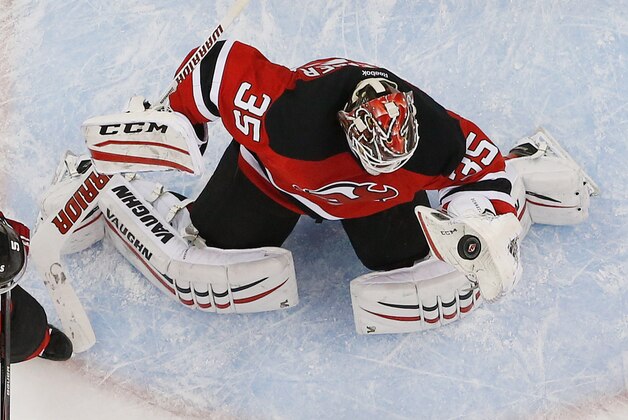 NEWARK, NJ - MARCH 03: Cory Schneider #35 of the New Jersey Devils makes a glove against the Nashville Predators during the game at the Prudential Center on March 3, 2015 in Newark, New Jersey.  (Photo by Andy Marlin/NHLI via Getty Images)