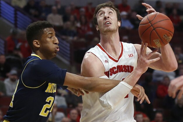 Wisconsin's Frank Kaminsky (44) is fouled by Michigan's Aubrey Dawkins (24) in the first half of an NCAA college basketball game in the quarterfinals of the Big Ten Conference tournament, Friday, March 13, 2015, in Chicago. (AP Photo/Kiichiro Sato)