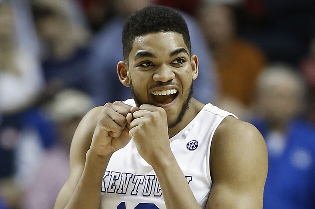 Kentucky forward Karl-Anthony Towns (12) celebrates a goal against the Florida during the second half of an NCAA college basketball game in the quarter final round of the Southeastern Conference tournament, Friday, March 13, 2015, in Nashville, Tenn. (AP Photo/Steve Helber)
