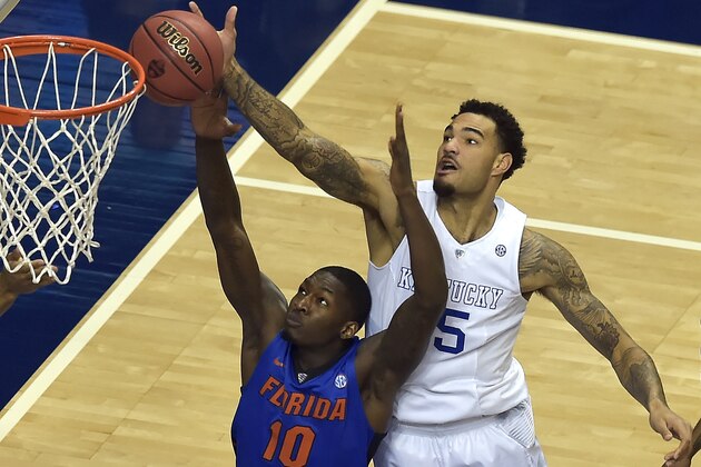 Kentucky forward Willie Cauley-Stein (15) shoots against Florida forward Dorian Finney-Smith (10) during the first half of an NCAA college basketball game in the quarter final round of the Southeastern Conference tournament, Friday, March 13, 2015, in Nashville, Tenn. (AP Photo/Mike Stewart)