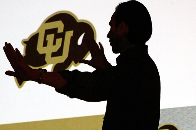 Chris McClure, design director for Nike Team Sports of New York, explains the difference in the new design of the University of Colorado logo during a presentation at the university in Boulder, Colo., on Tuesday, May 10, 2005.  The buffalo is slightly tilted to the right to give it an