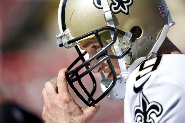 New Orleans Saints quarterback Drew Brees (9) adjusts his helmet as he takes the field during an NFL football game against the Tampa Bay Buccaneers on Sunday, Dec. 28, 2014, in Tampa, Fla. (AP Photo/Brian Blanco)
