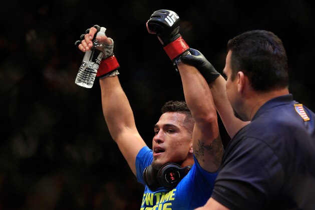 LAS VEGAS, NV - DECEMBER 06:  Anthony Pettis reacts after defeating Gilbert Menendez in their lightweight title fight during the UFC 181 event at the Mandalay Bay Events Center on December 6, 2014 in Las Vegas, Nevada.  (Photo by Alex Trautwig/Getty Images)