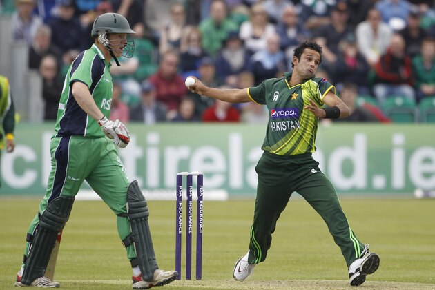 Pakistan's Asad Ali, right, bowling as Ireland batsman Kevin O'Brien, left, looks on during their One Day Cricket International at Clontarf Cricket Club, Dublin, Ireland, Sunday, May 26, 2013.  (AP Photo/Peter Morrison)